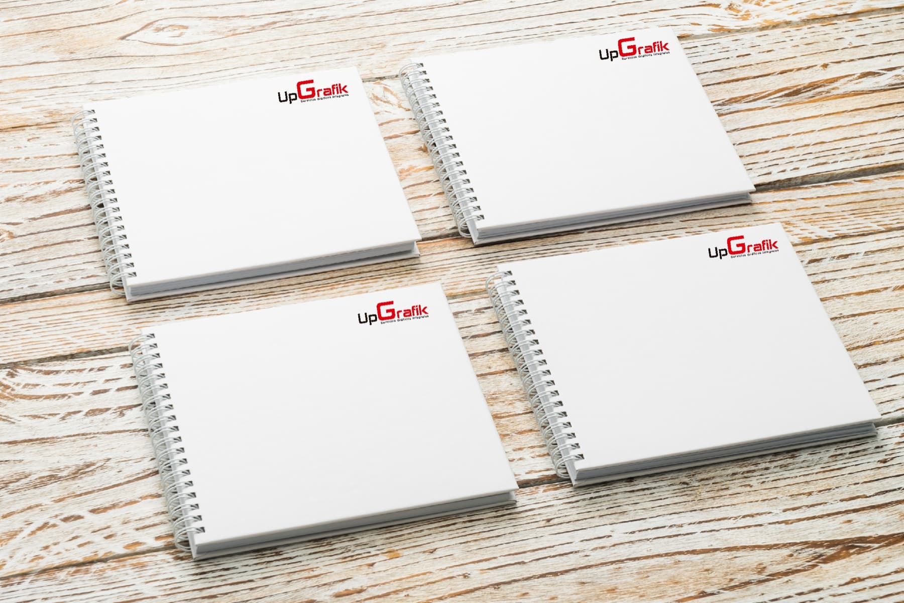 Set de cuadernos anillados con la identidad de UpGrafik aplicada a la tapa.